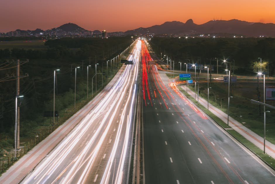 Rodovia com rastro de luzes de veículos ao entardecer