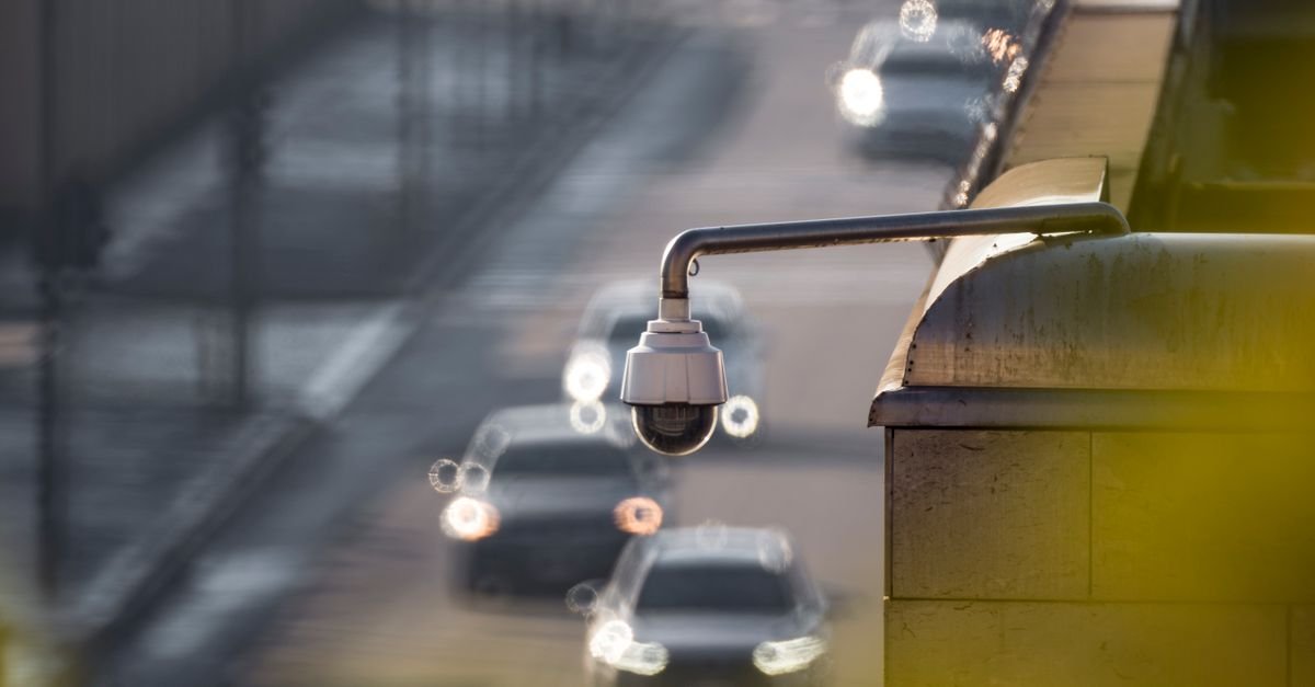 Câmera de videomonitoramento instalada sobre via com carros em movimento