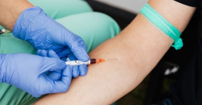 Profissional de saude coleta amostra de sangue do braco de um paciente