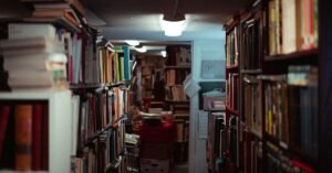 Corredor de livraria com estantes lotadas de livros dos dois lados