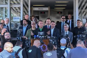 O ex-presidente Jair Bolsonaro fala a jornalistas em coletiva de imprensa ao lado do senador Flávio Bolsonaro e de outros parlamentares