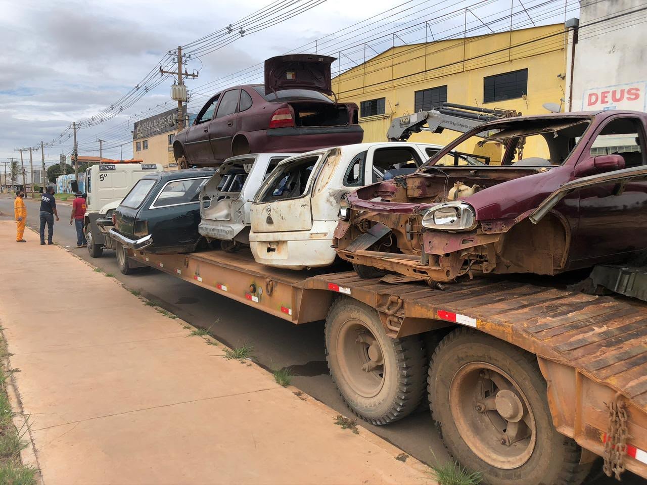 Caminhão-prancha carregado com quatro carcaças de veículos recolhidas em operação no Distrito Federal