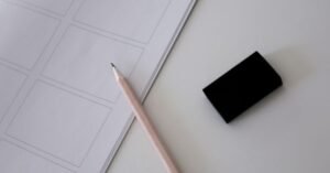 Lapis, borracha e folha de prova em branco sobre mesa clara