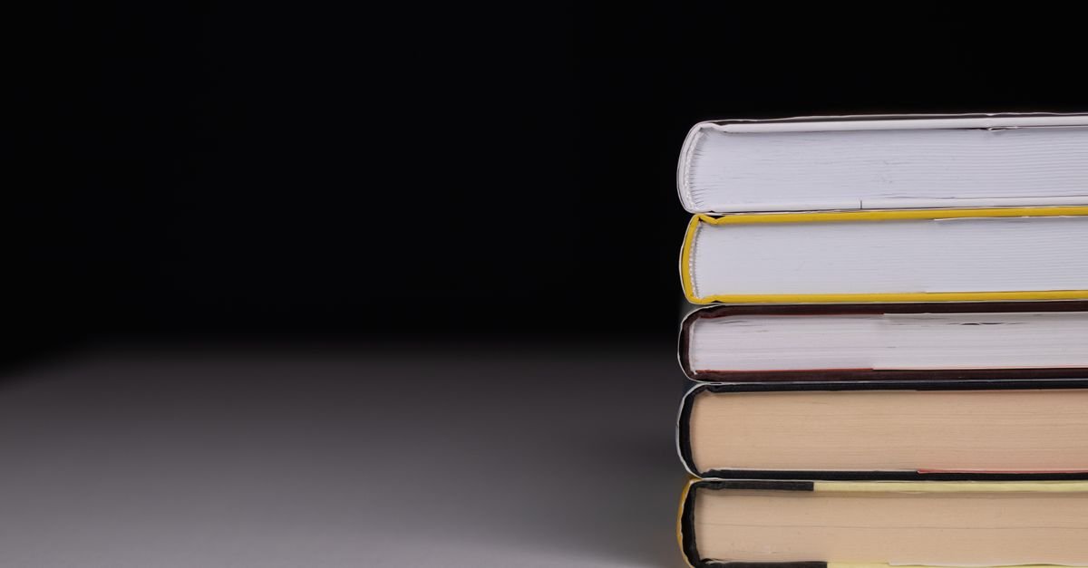 Pilha de livros de capa dura sobre fundo preto