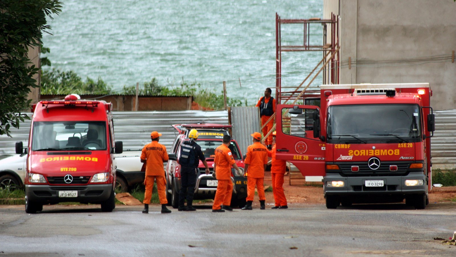 Viaturas do Corpo de Bombeiros do DF e militares de uniforme laranja em uma ocorrência às margens do Lago Paranoá