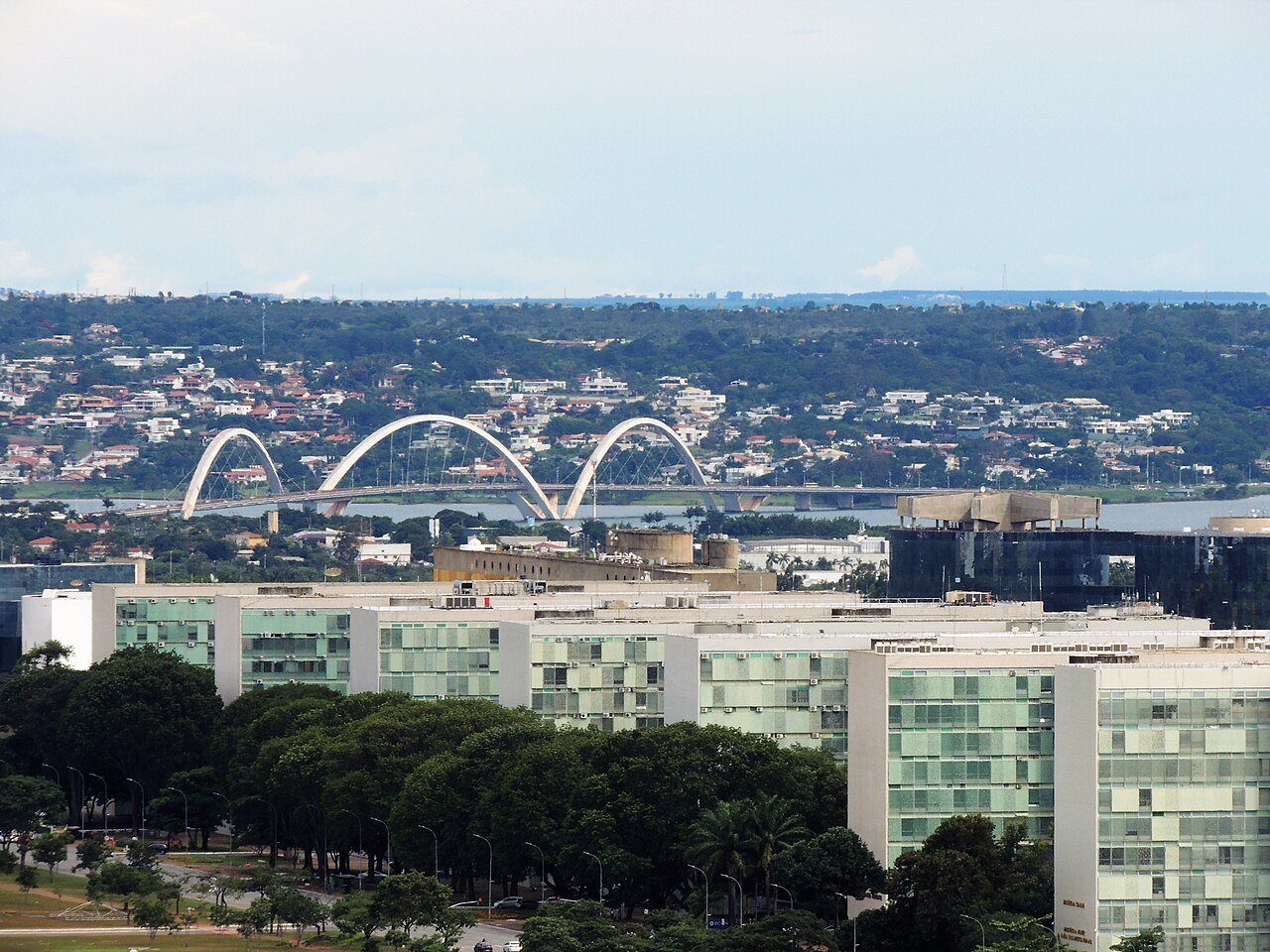Ponte JK vista de longe, com os arcos sobre o Lago Paranoá e os prédios da Esplanada em primeiro plano; foto de arquivo